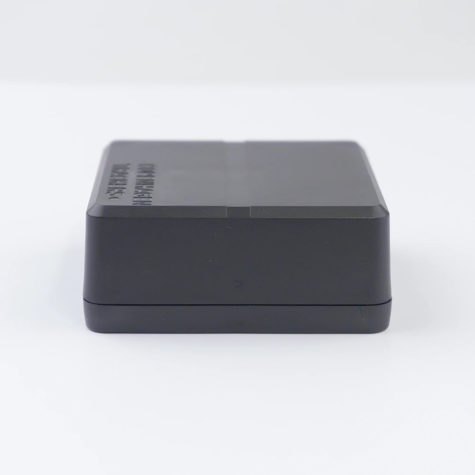 Side view of the Cobblestone 2.0 GPS tracker on a light grey background
