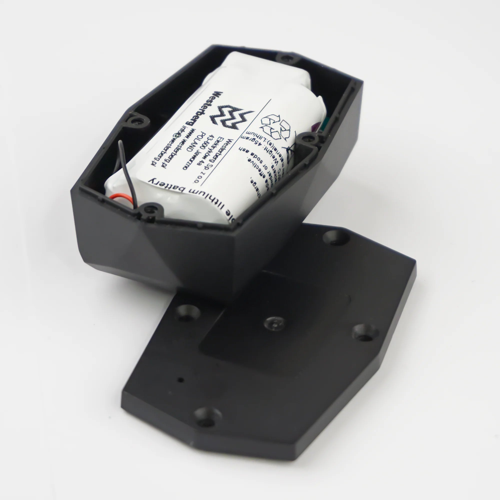 Gemstone GPS tracker from the back with the backside removed, showing the lithium battery inside.
