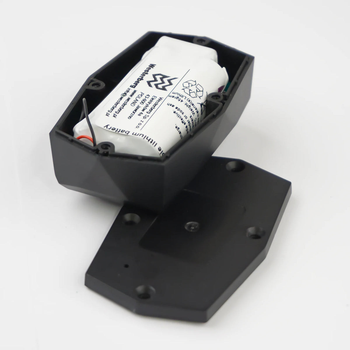 Gemstone GPS tracker from the back with the backside removed, showing the lithium battery inside.