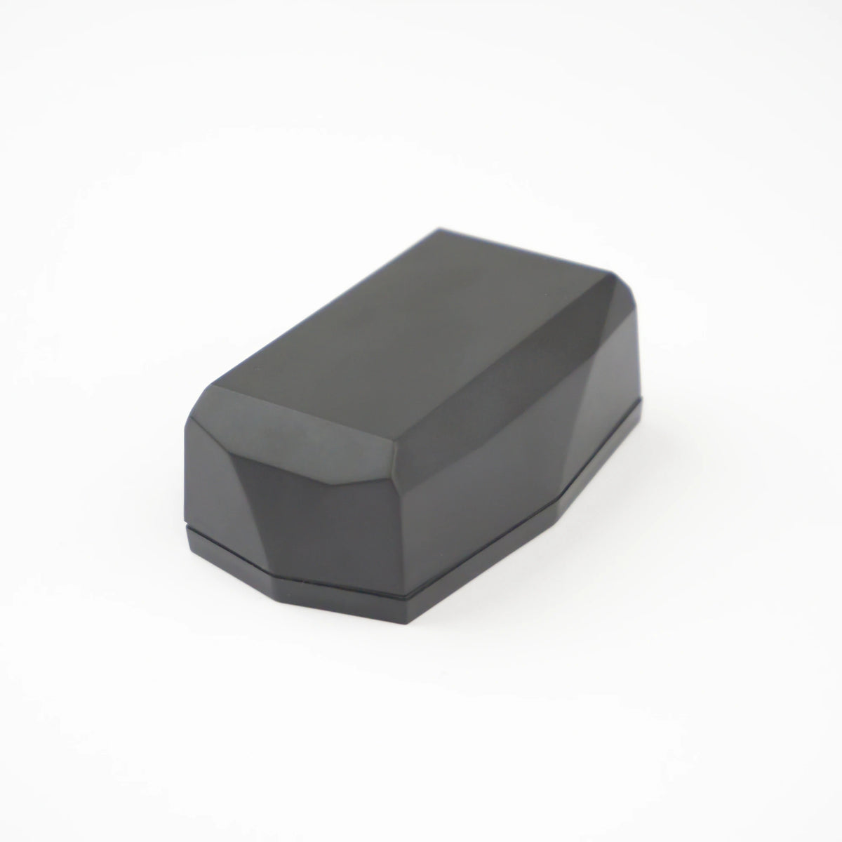 Gemstone GPS tracker; a dark gray diamond shaped design on a light grey background.